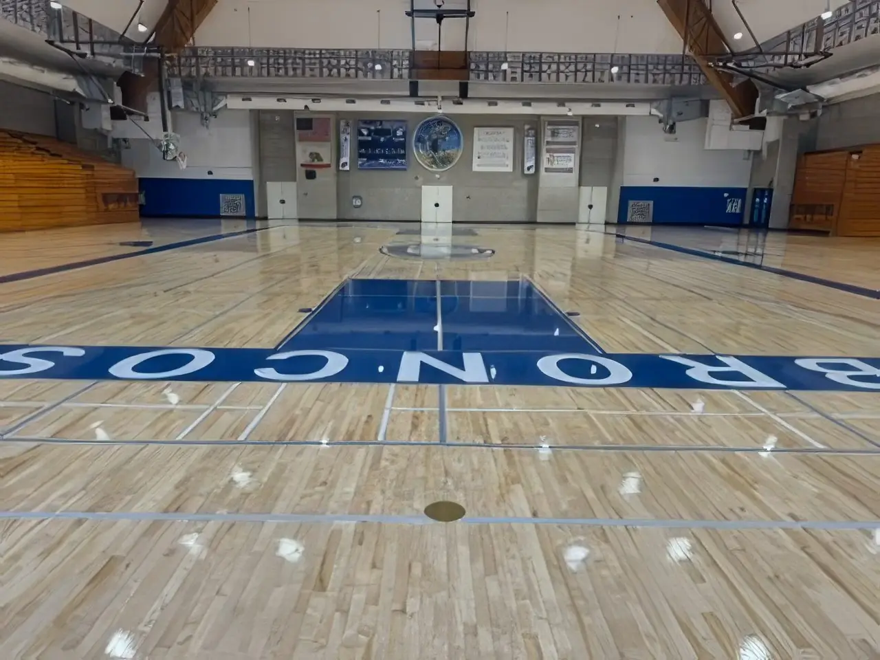 Refinished gymnasium court with painted Broncos lettering