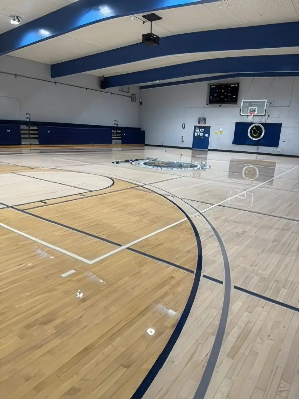 Gymnasium court beside wooden bleachers with fresh finish