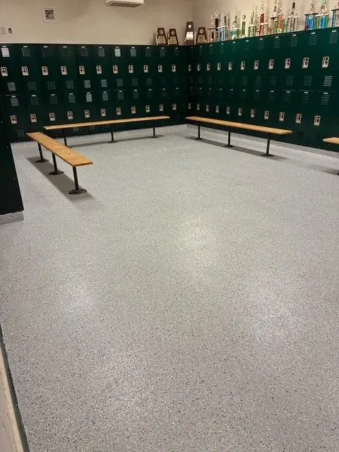 Team locker room with new resinous floor, benches and trophies