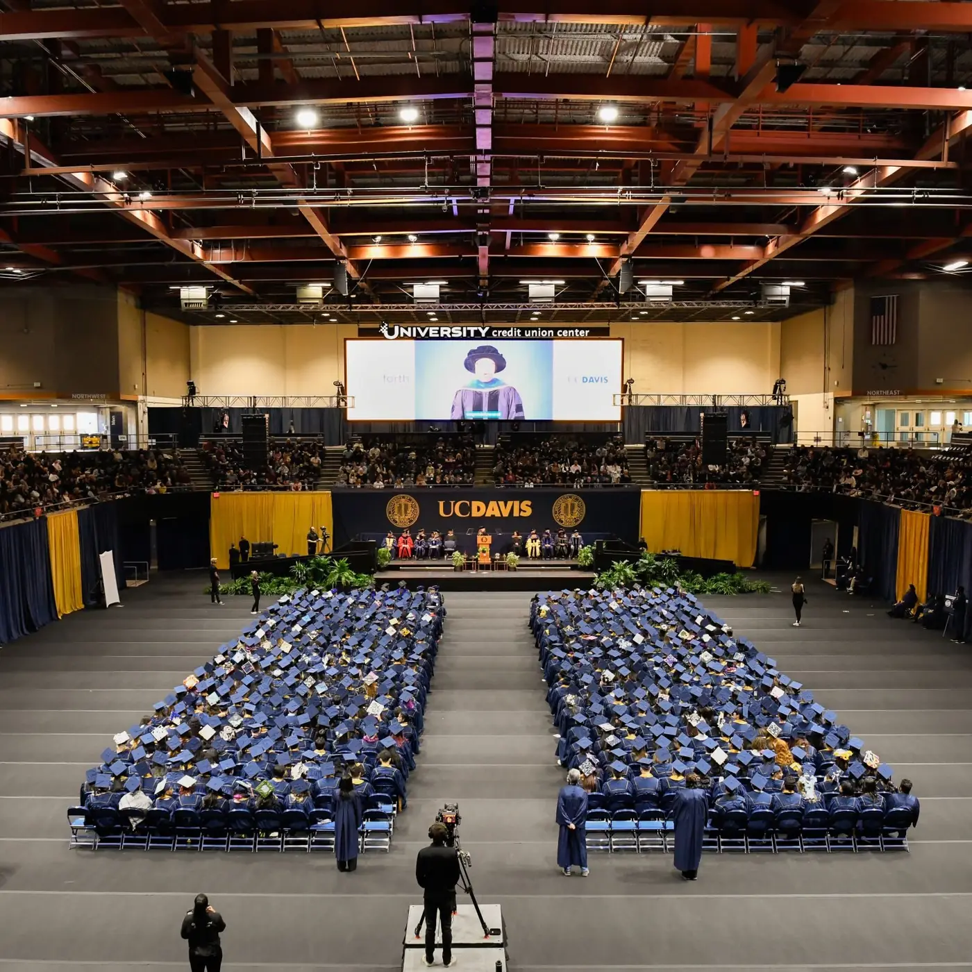 University commencement held on a covered arena court