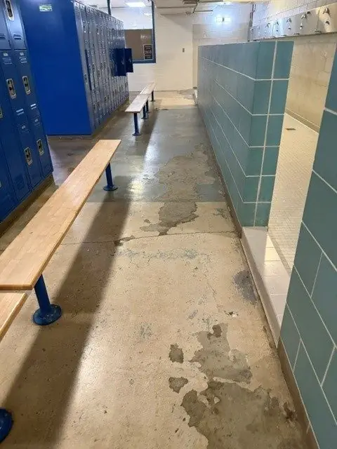 Before: bare stained concrete floor